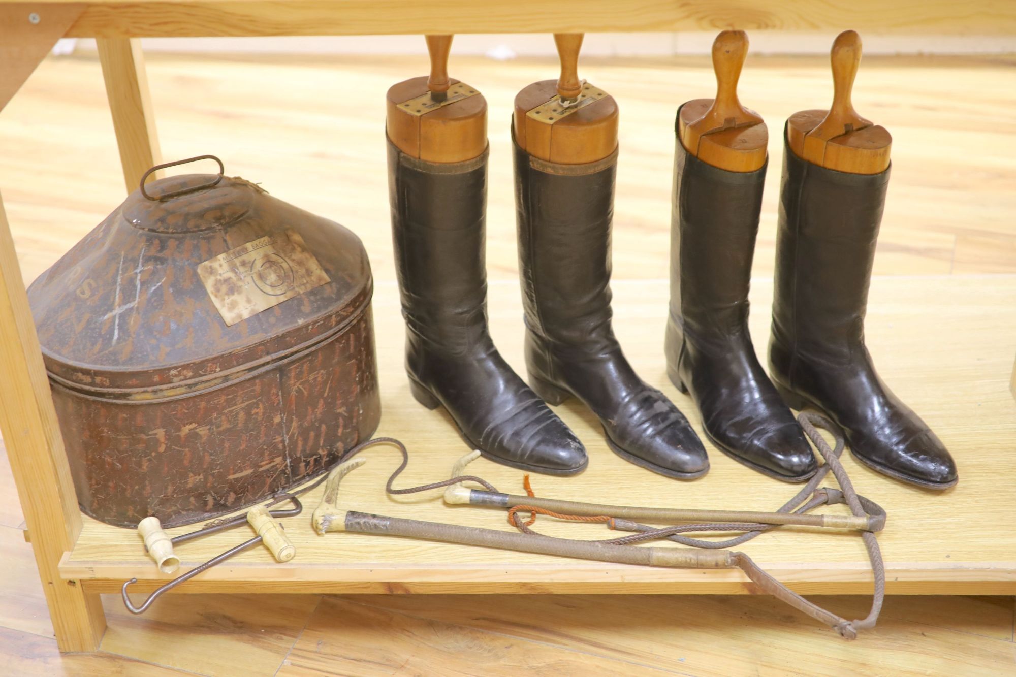 Two pairs of riding boots and trees together with two boot pulls and riding crops and a toleware hat box